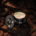 SHARK MOLD jar with the lid open over rocks showing product texture